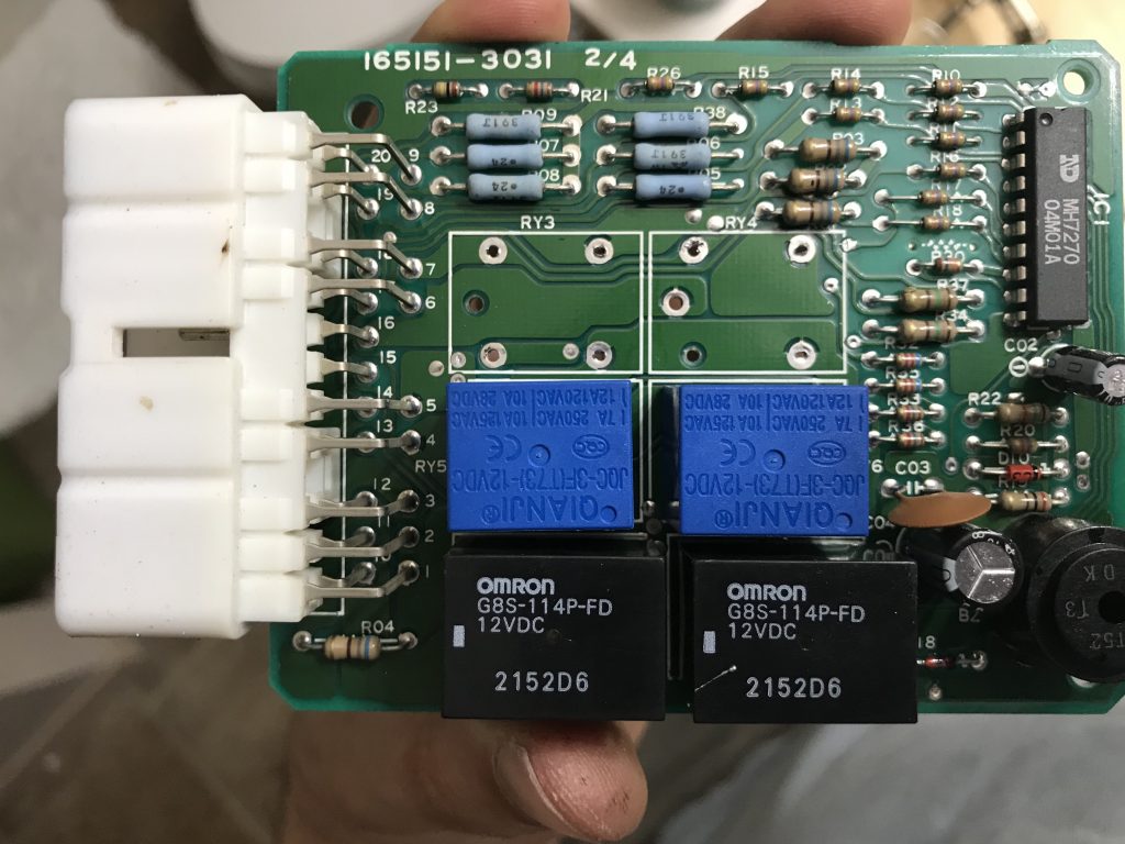 Rear window relay circuit board, showing 2 relays removed, 2 cheap Chinese relays, and 2 original relays