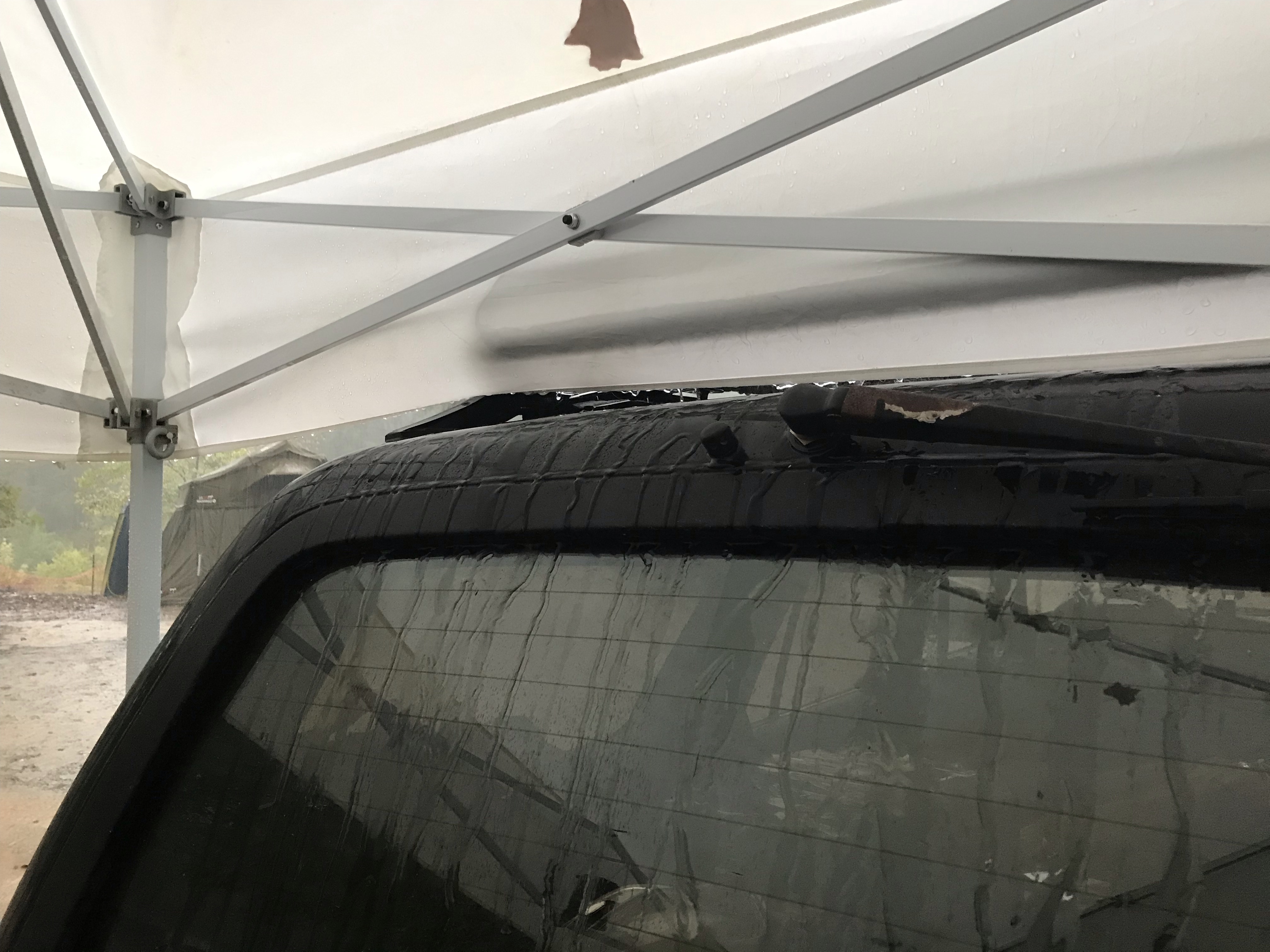 Rear window under cover with rain streaks