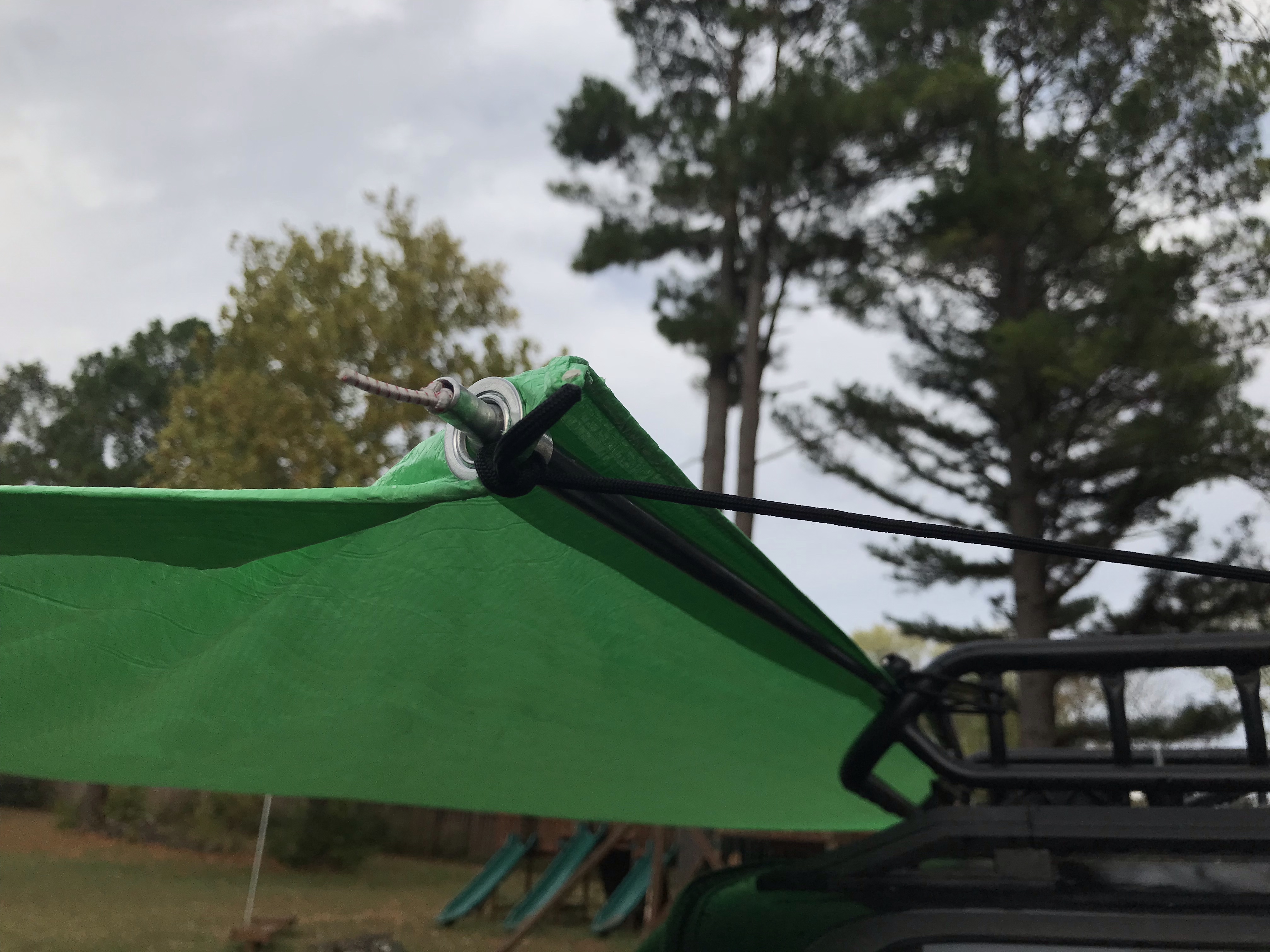 Detail showing strut, guy line to roof rack, and ball bungee holding strut to roof rack